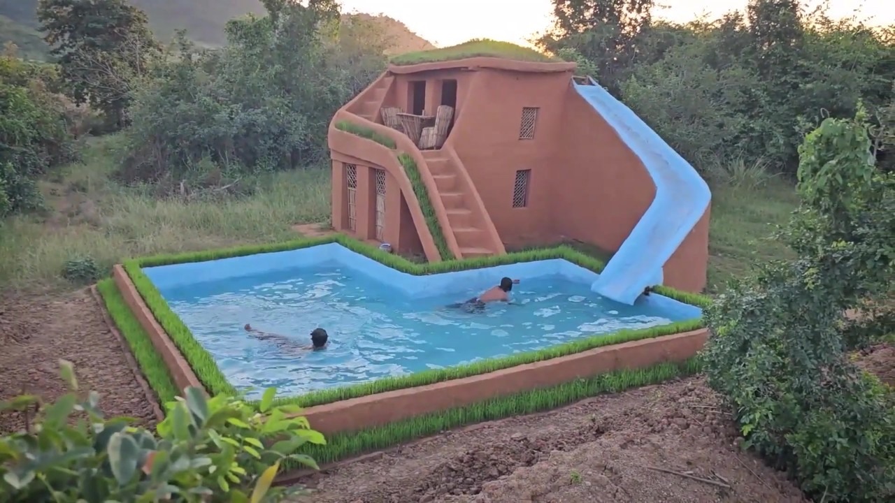 Swimmers use a blue swimming pool with a curved water slide