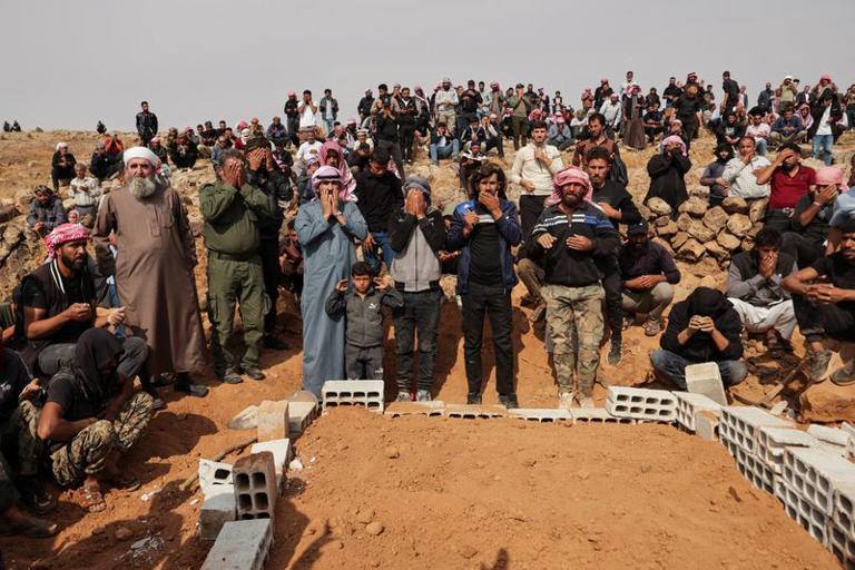 Mourners attend the funeral of four members of the same family, including three children, who were killed in a reported Jordanian airstrike in the town of Al-Mismiyah, in Syria's southern Daraa province, October 27, 2026. REUTERS/Khalil Ashawi