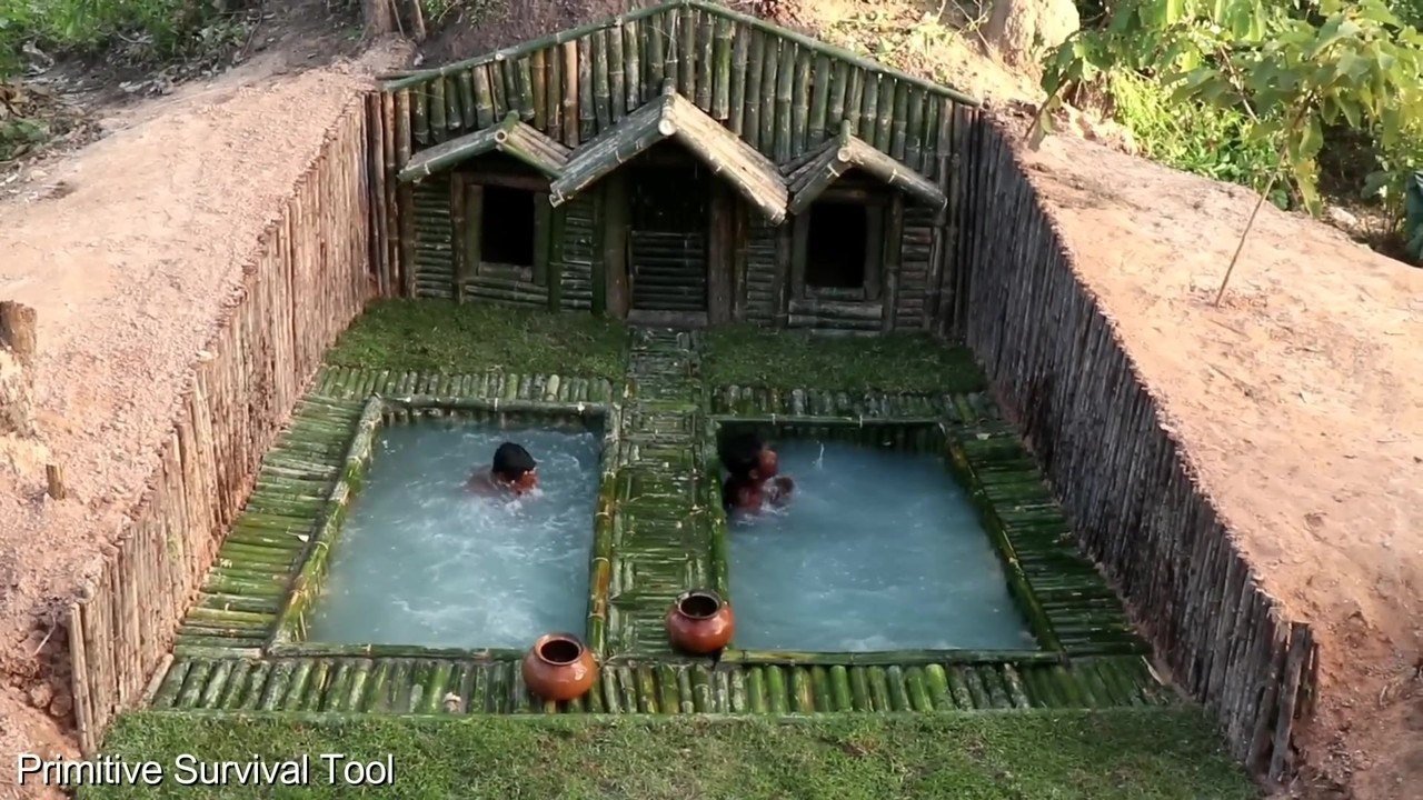 Bamboo house beneath tree roots with two pools