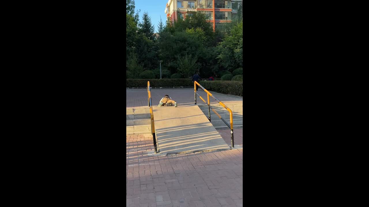 Boy loses control of skateboard and crashes on a park ramp in Jilin, China