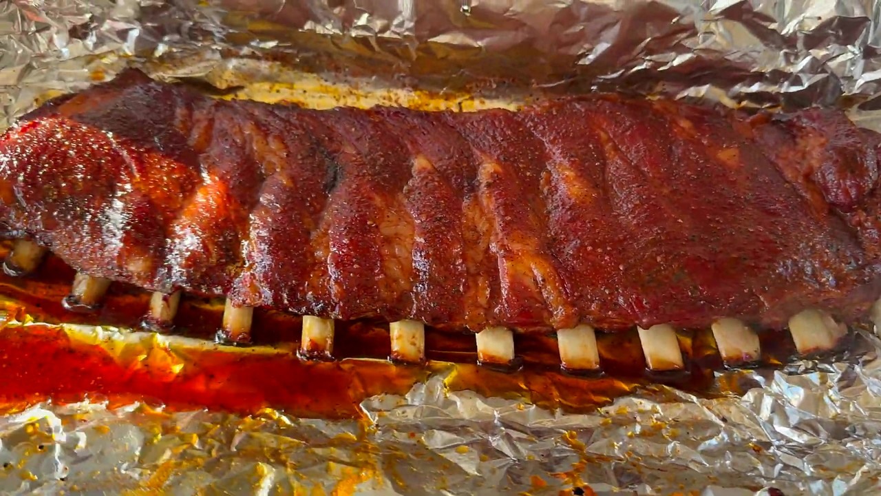 CJ cooks St. Louis ribs low and slow on a Ninja FlexFlame grill