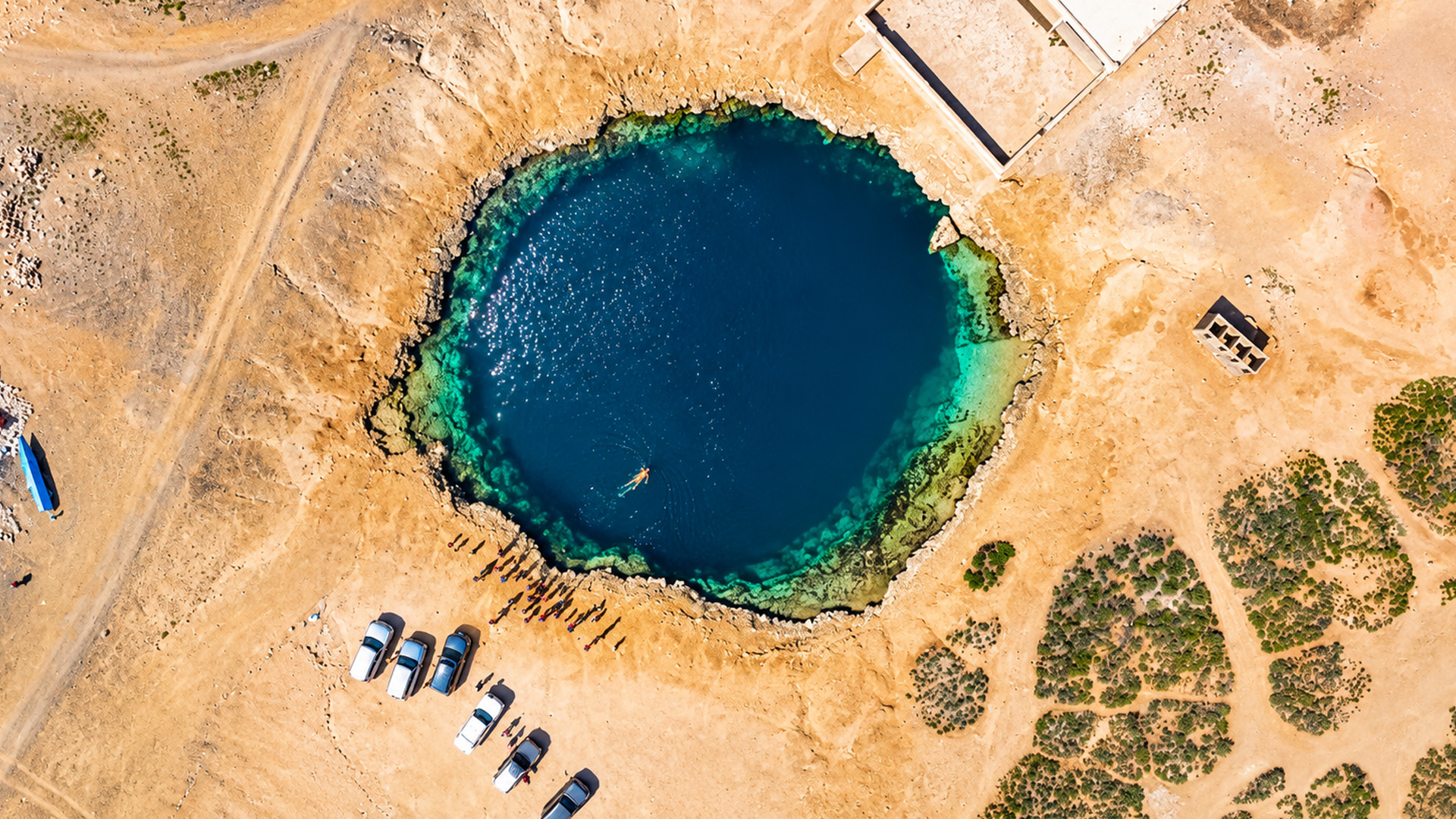 One circular pool in a vast sandy landscape