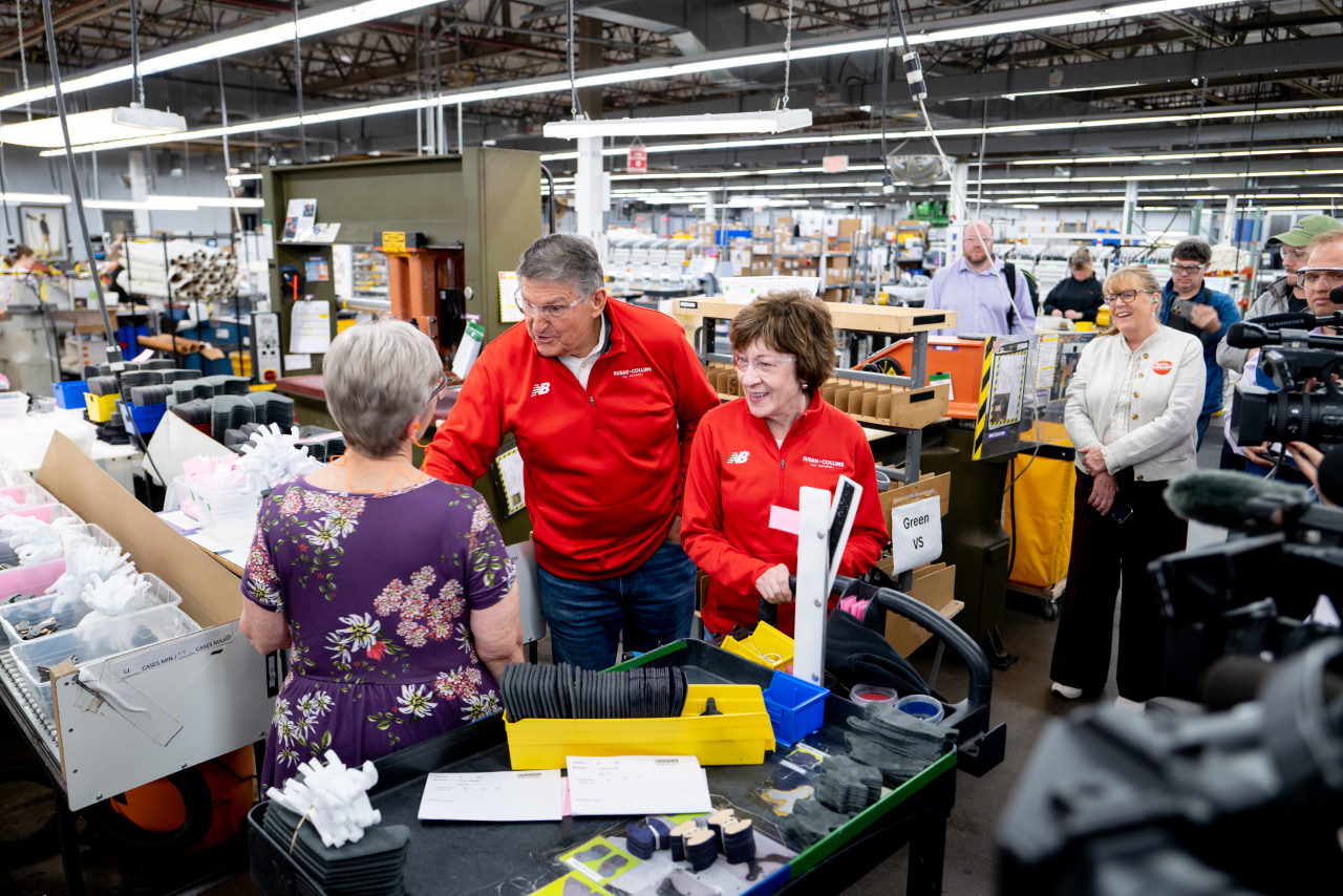 Collins campaigns Oct. 21 with another centrist, former West Virginia Sen. Joe Manchin, at a New Balance shoe factory in Norway, Maine.
