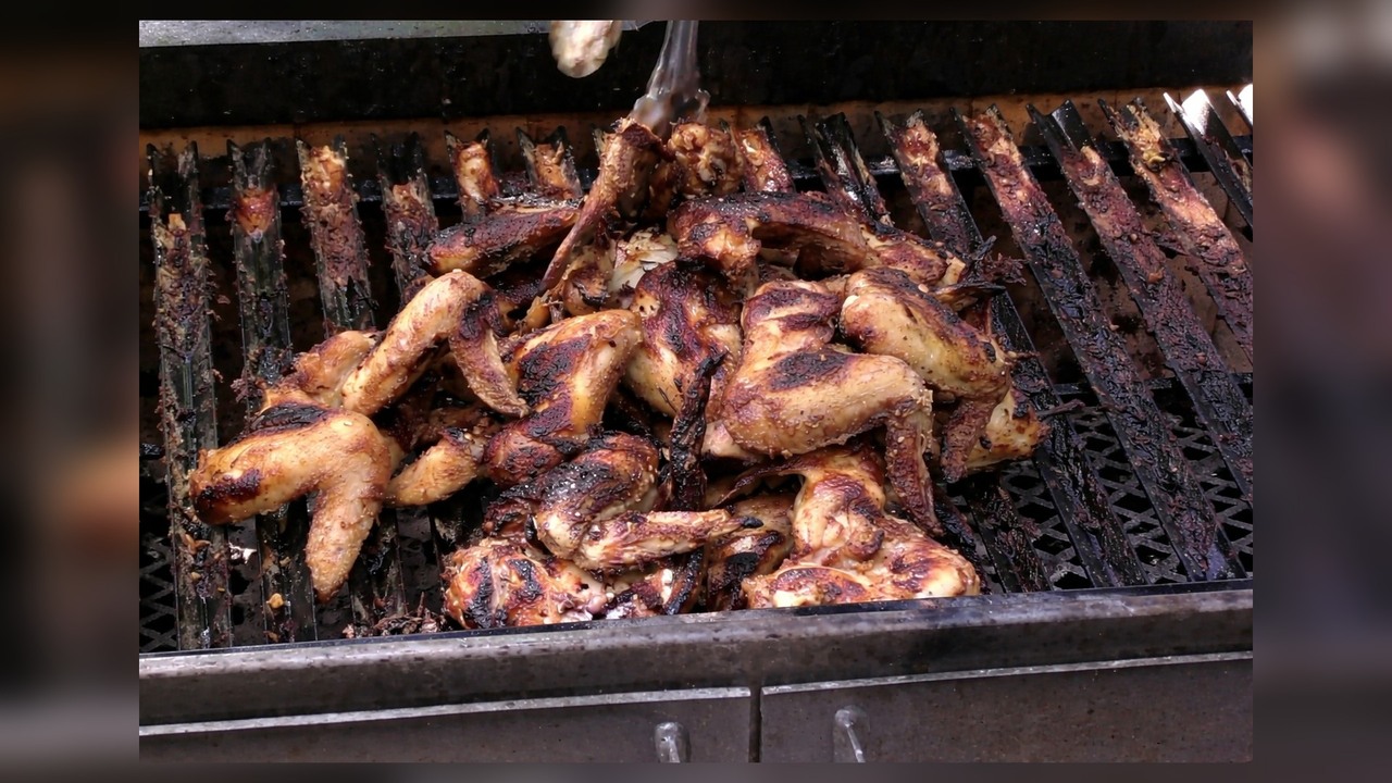 Chicken wings in sour cream onion sauce on the grill