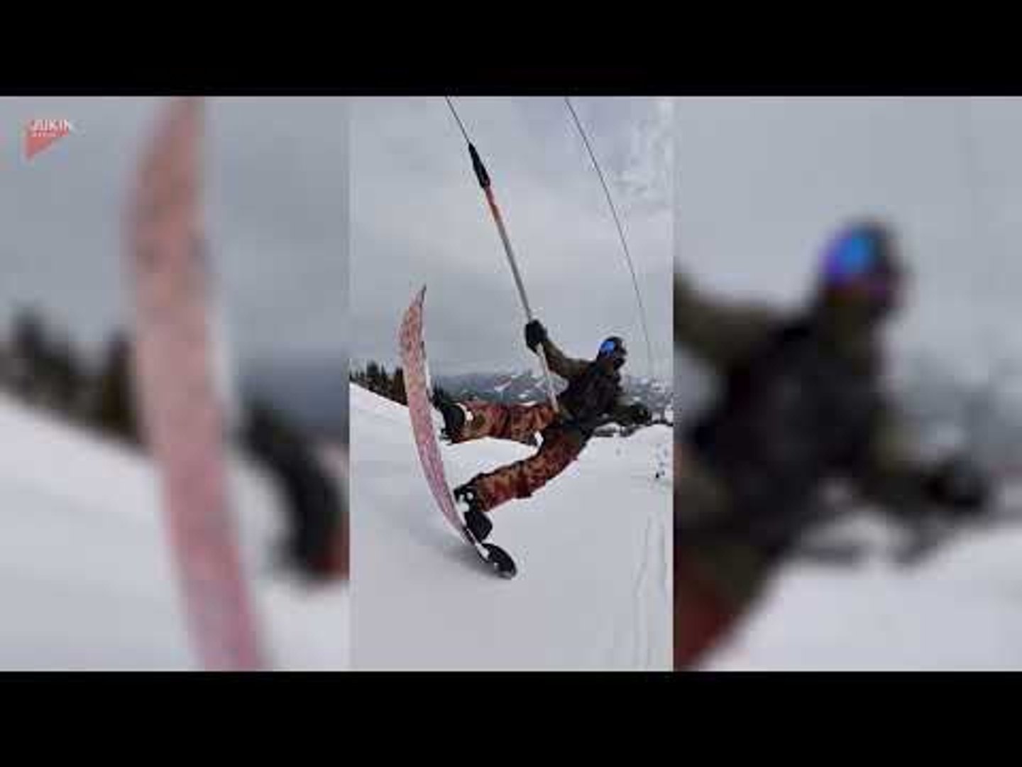 Snowboarder pulls off manual on T-bar lift