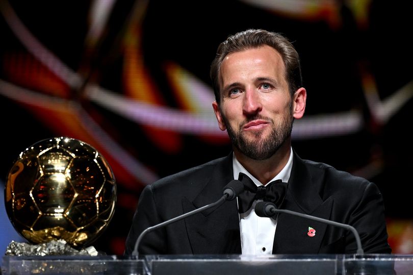 Harry Kane of FC Bayern Munich and England speaks to the media on stage after winning the Men's Ballon d'Or award during the 70th Ballon D'Or Ceremony