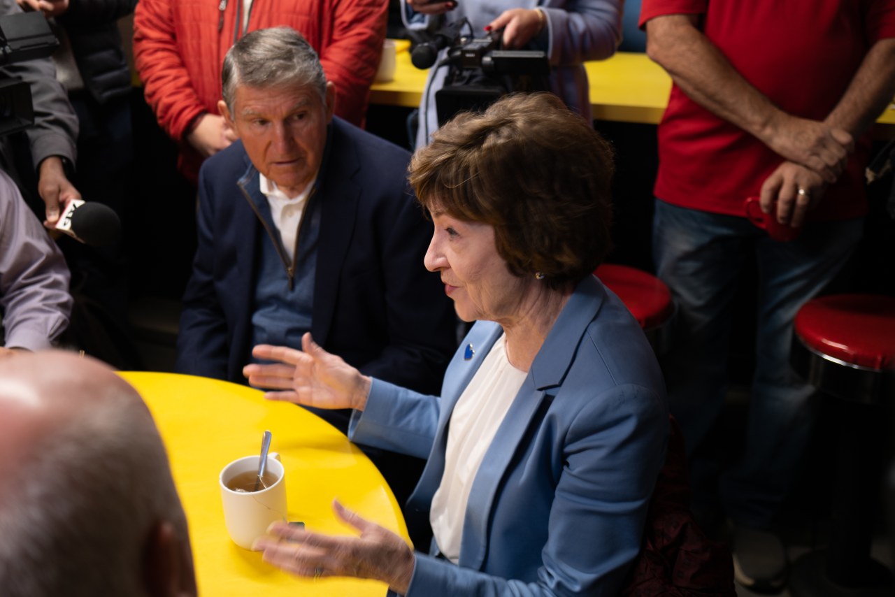 Collins and Manchin at Simones' Hot Dog Stand, where they spoke with customers and people from the town.