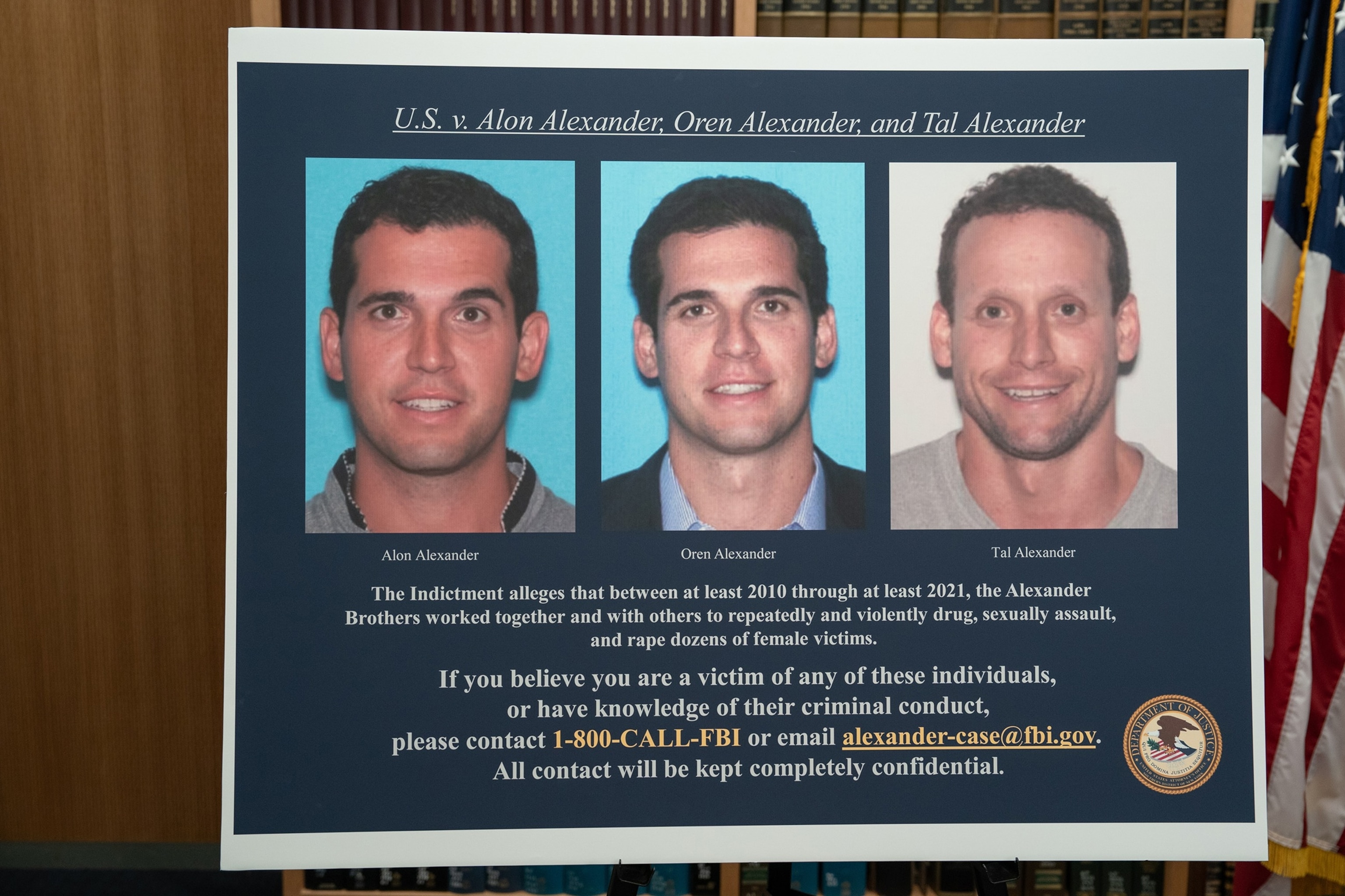 Barry Williams/New York Daily News via Getty Images - PHOTO: A poster of celebrity real estate agents Tal and Oren Alexander along with their brother Alon is pictured during a press conference by the U.S. Attorney for the Southern District of New York, Dec. 11, 2024, in New York City.