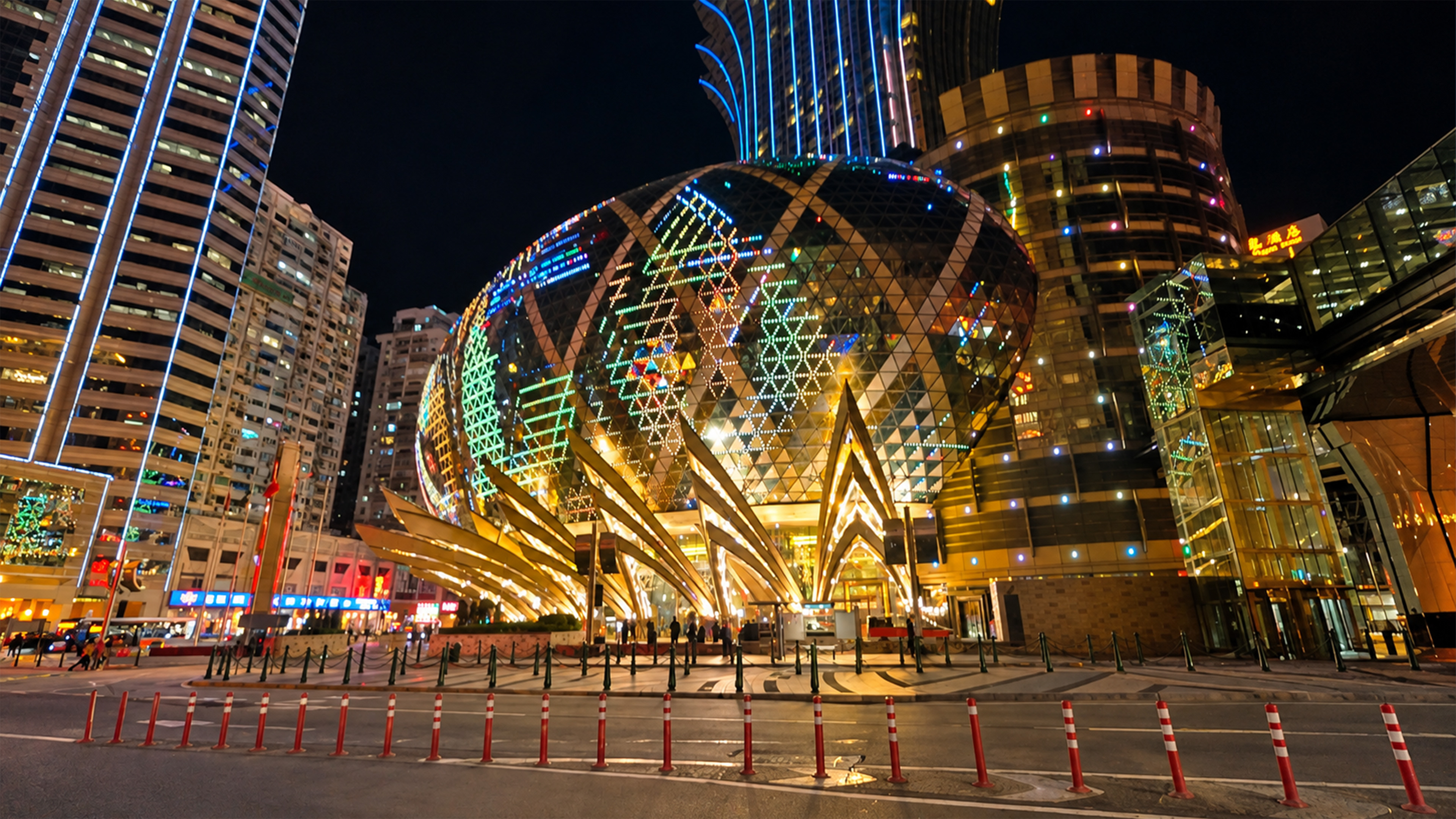 Macau's giant oval casino glows with colorful lights at night