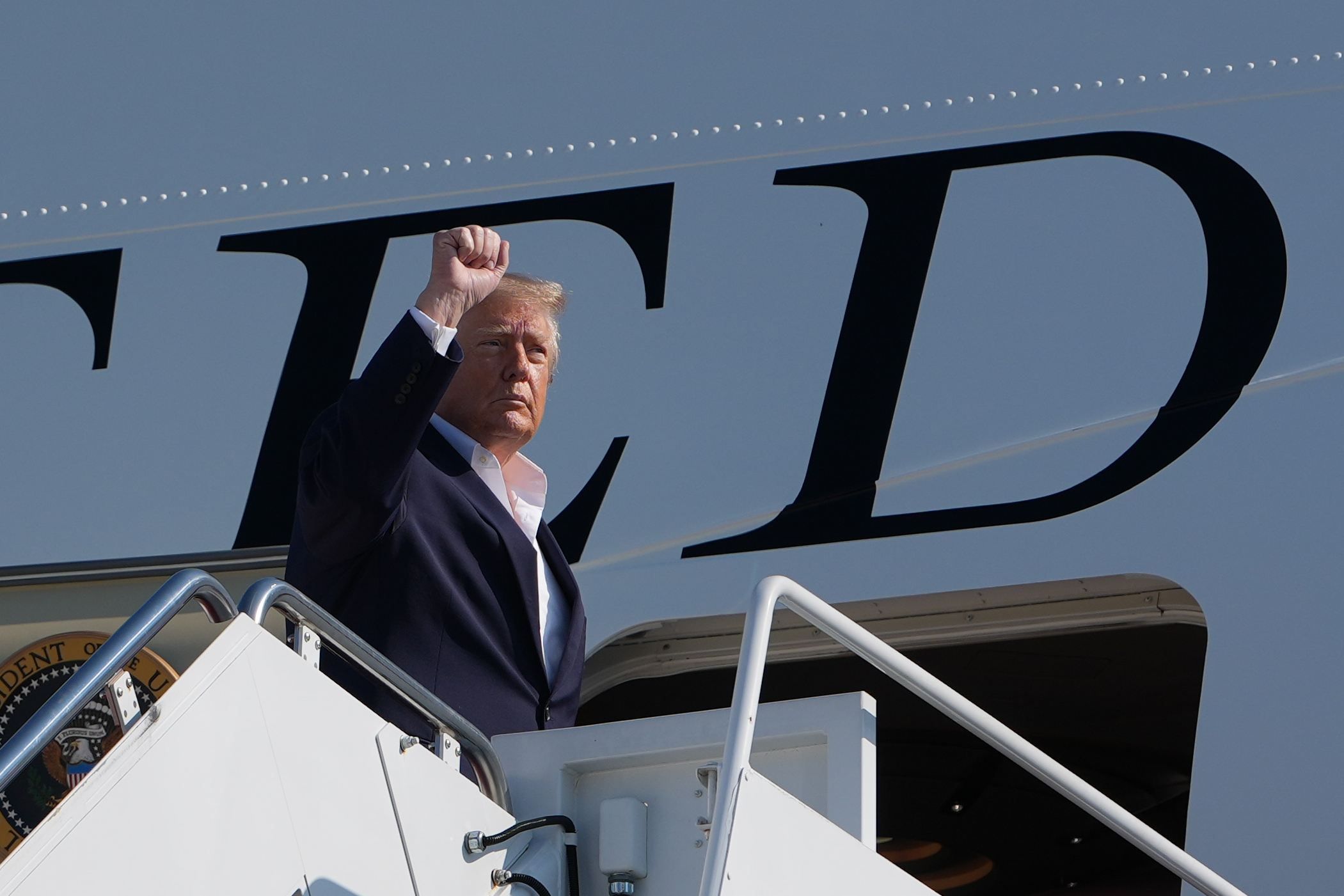 President Donald Trump raises his fist as he boardsAir Force One, Tuesday, Oct. 27, 2026, at Joint Base Andrews, Md. (AP Photo/Alex Brandon)