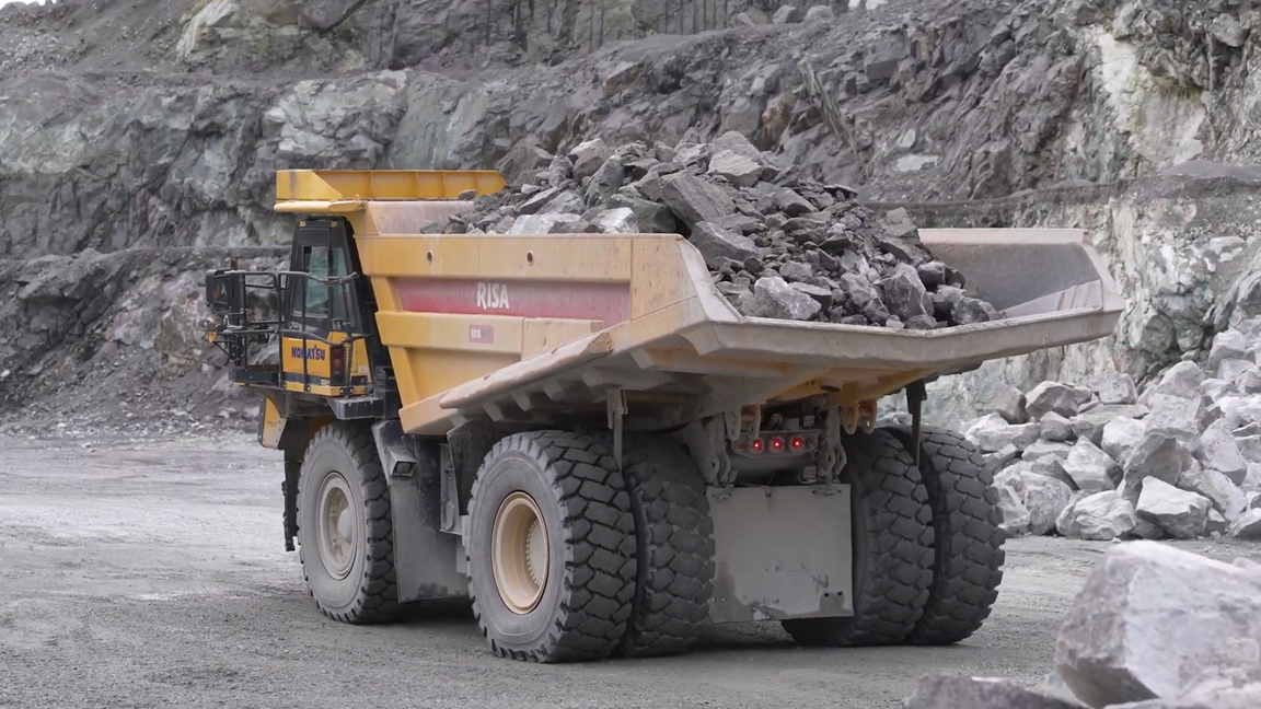 Massive mining dump truck hauling heavy loads of rocks