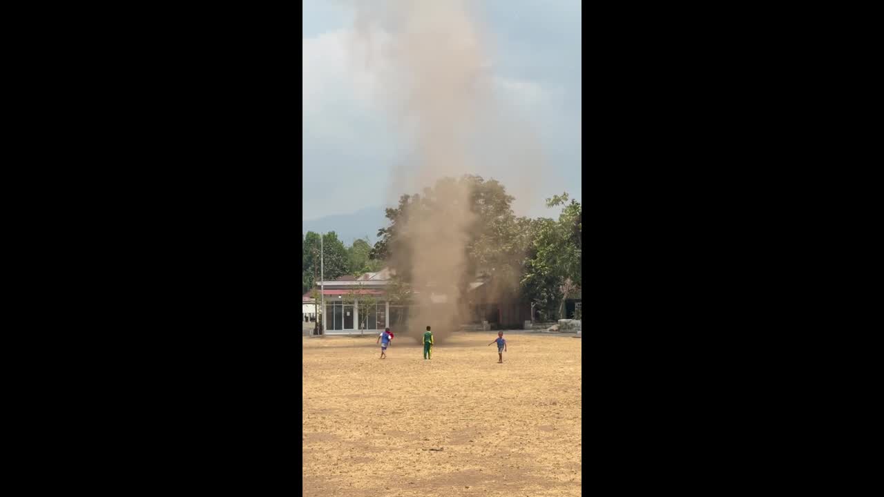 Dust devil spins in middle of field in Indonesia