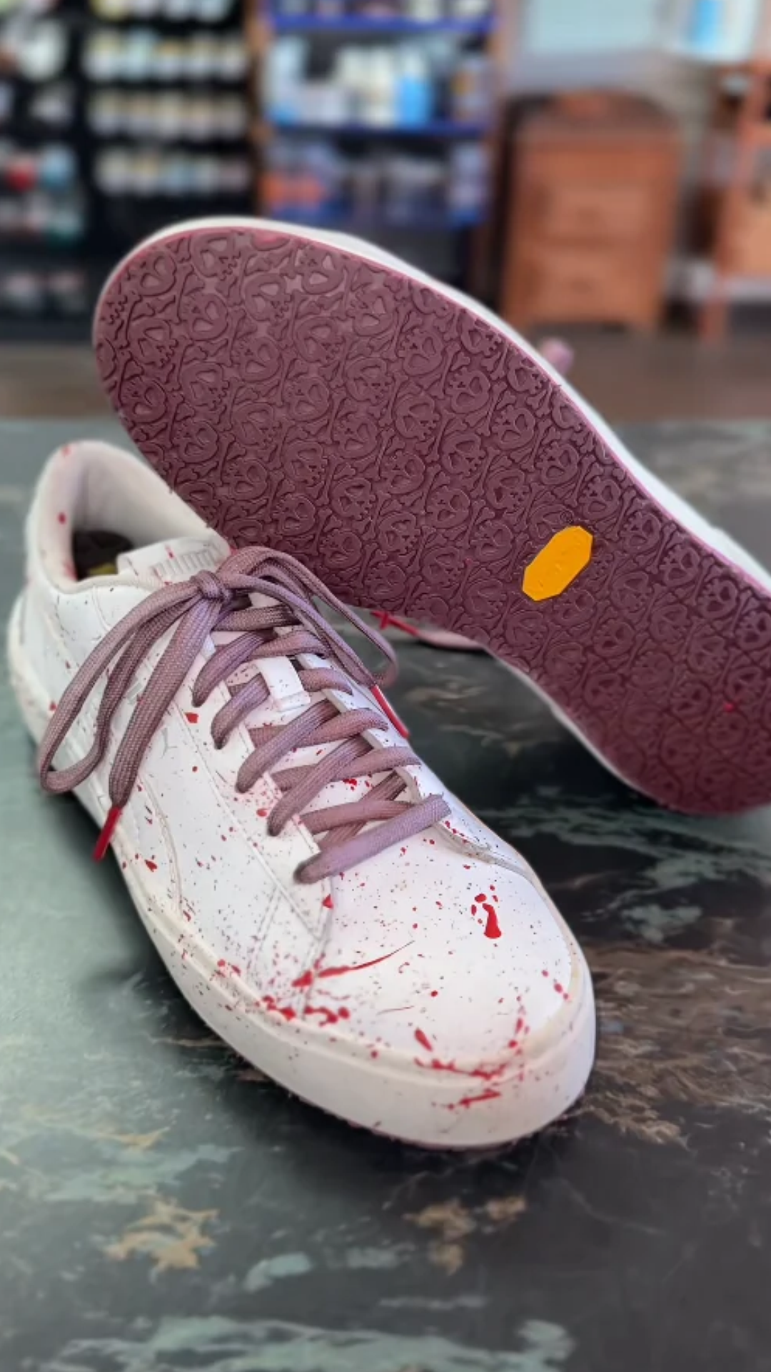 Transforming plain white sneakers with red paint splatter