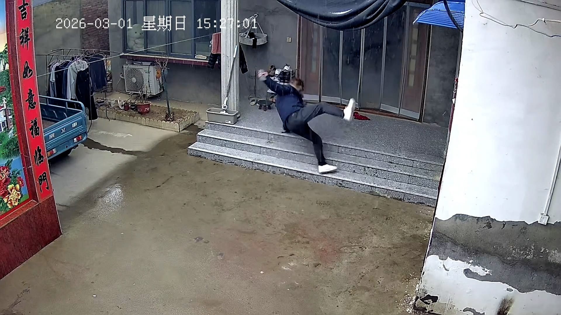 Moment man slips twice trying to climb snow-covered steps