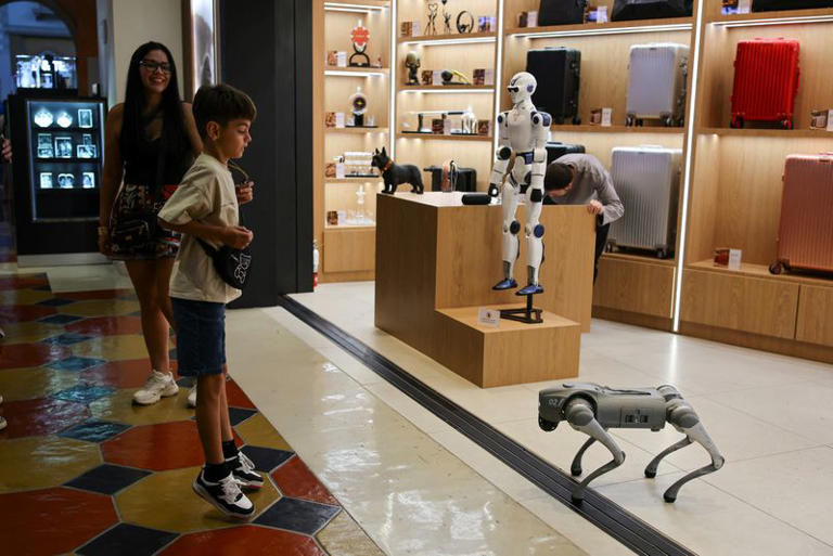 A visitor reacts to a remote-controlled robot at The Venetian Resort in Las Vegas, Nevada, US, October 3, 2026. By 2035, AI and automation could put up to 92,000 Southern Nevada hospitality jobs at risk, or roughly one-third of that workforce, according to an analysis by RCG Economics. REUTERS/Daniel Cole