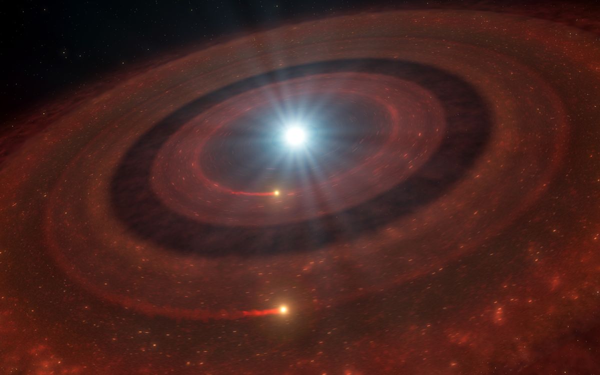 Revenant planets – one as big as Pluto – discovered in the debris disk of a white dwarf