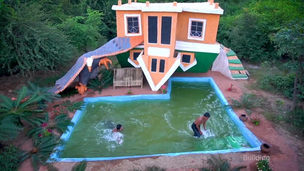 Handmade forest pool beside an upside-down mud house