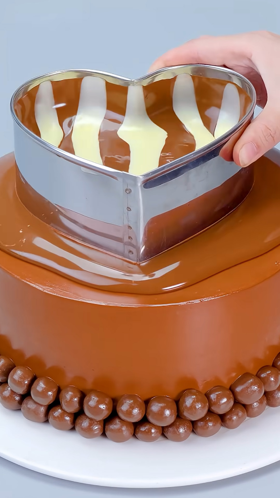Creative cake design featuring glossy chocolate and decadent layers
