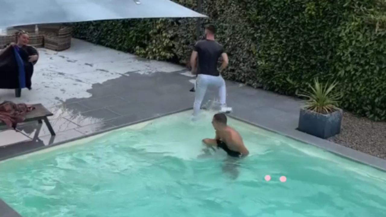 Man catches friend off guard with a surprise pool splash
