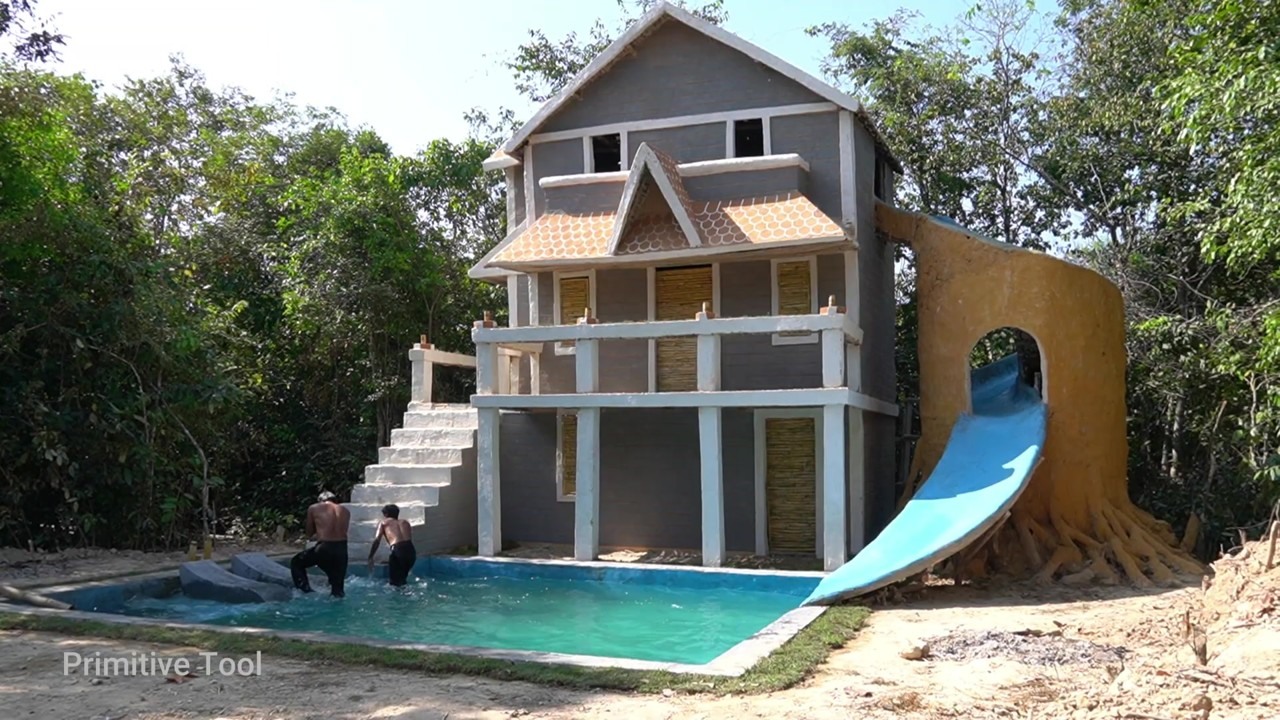Finished two-story underground house with a blue slide to a pool