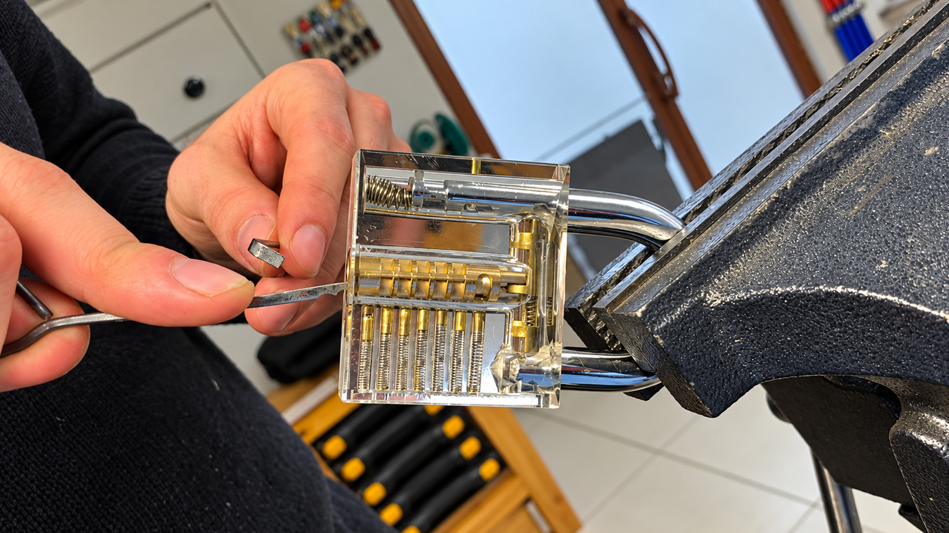 Watch a locksmith file a wave rake from steel wire to open pin cylinders