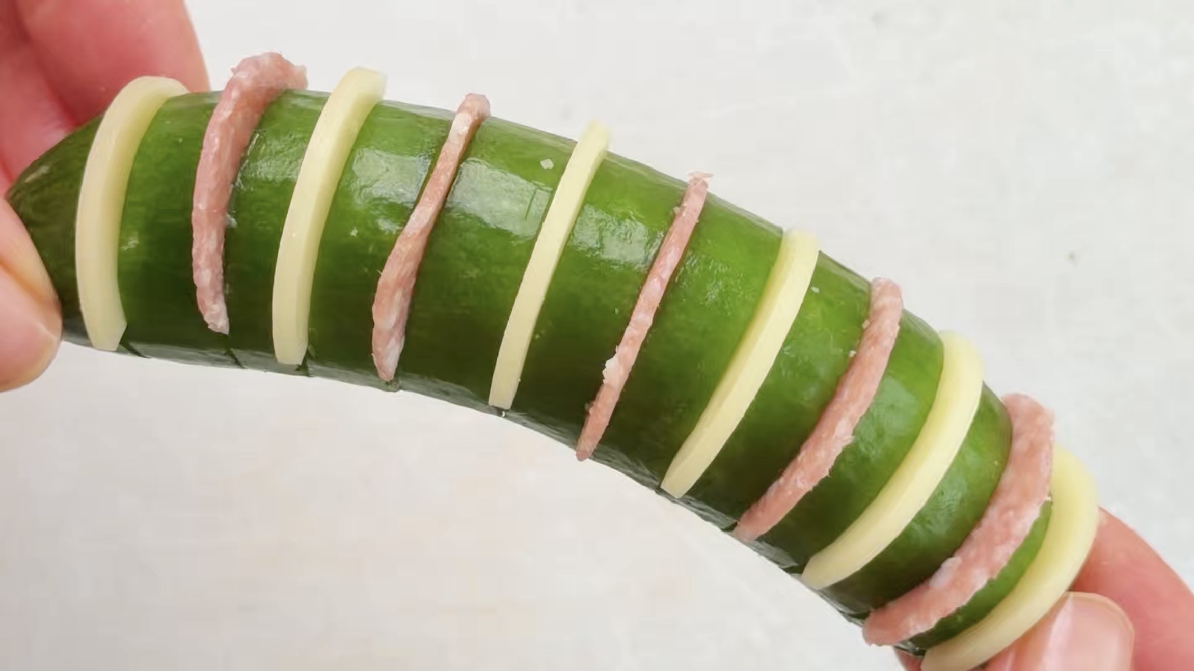 Cheese and salami stuffed hasselback cucumbers