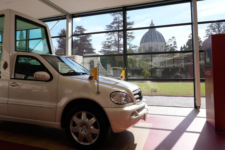 A popemobile exhibition is unveiled at the Vatican, featuring the ...