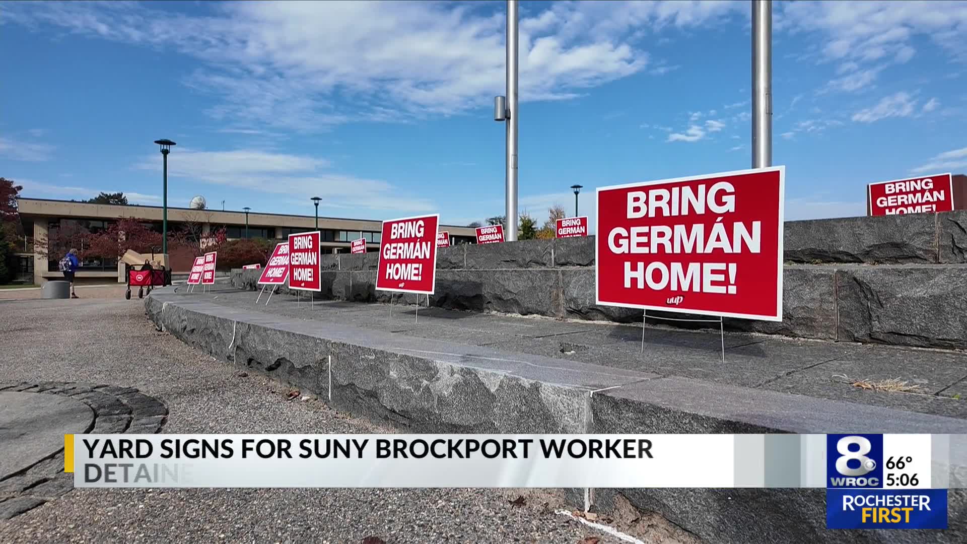 Yard signs handed out in support of detained SUNY Brockport employee
