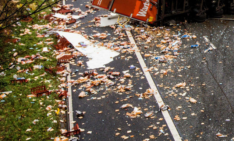 Lorry full of Warburtons bread sheds its load across carriageway