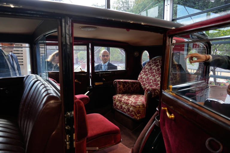 A popemobile exhibition is unveiled at the Vatican, featuring the ...