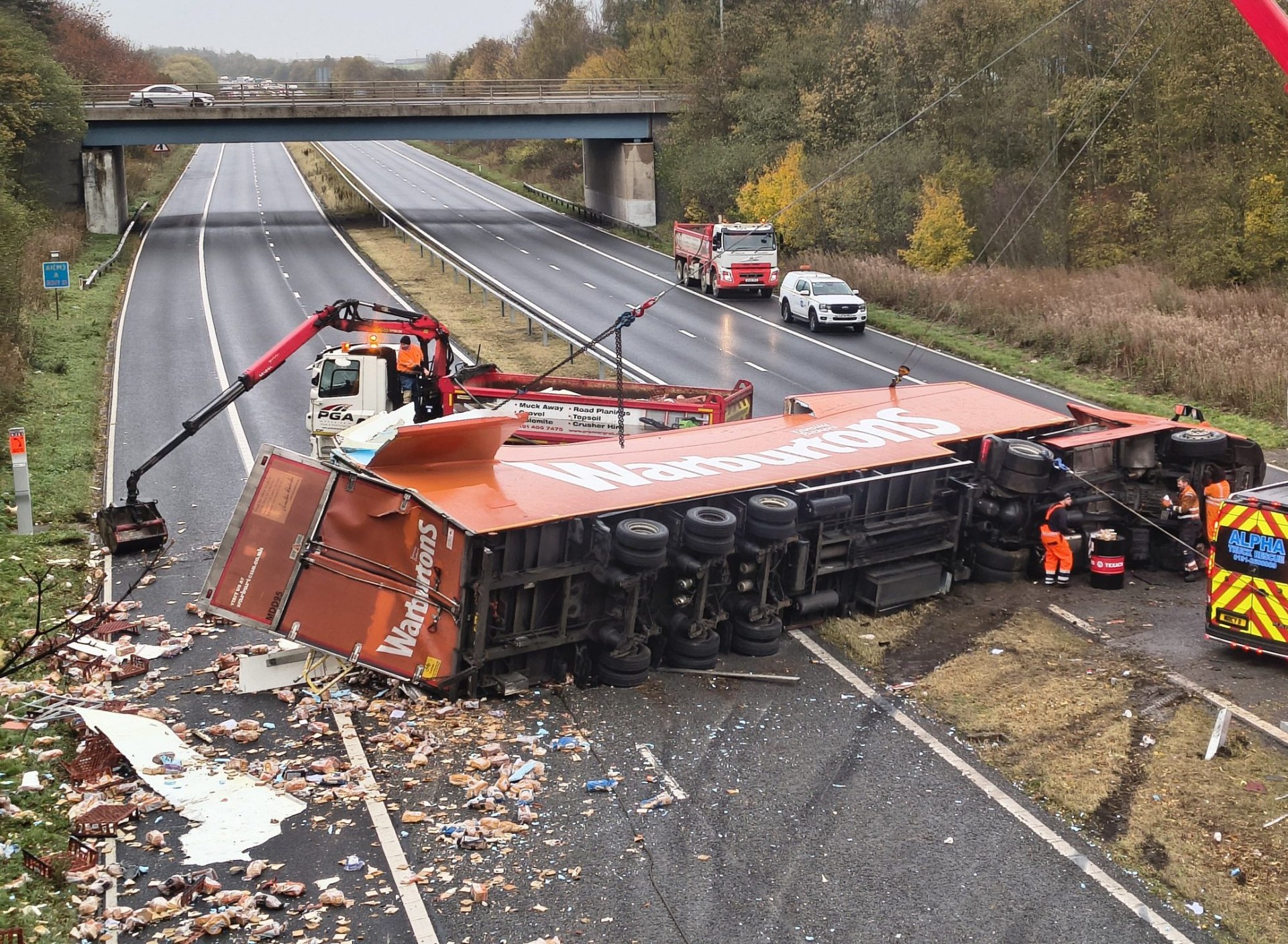 Lorry full of Warburtons bread sheds its load across carriageway