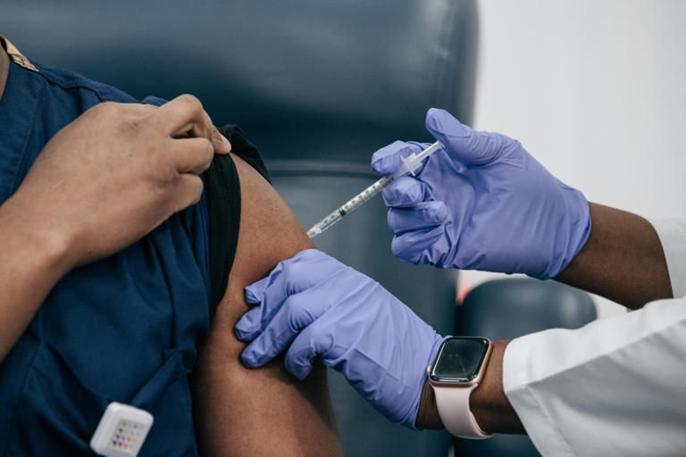 The COVID booster and flu shot: Can you get both at once? Doctors ...