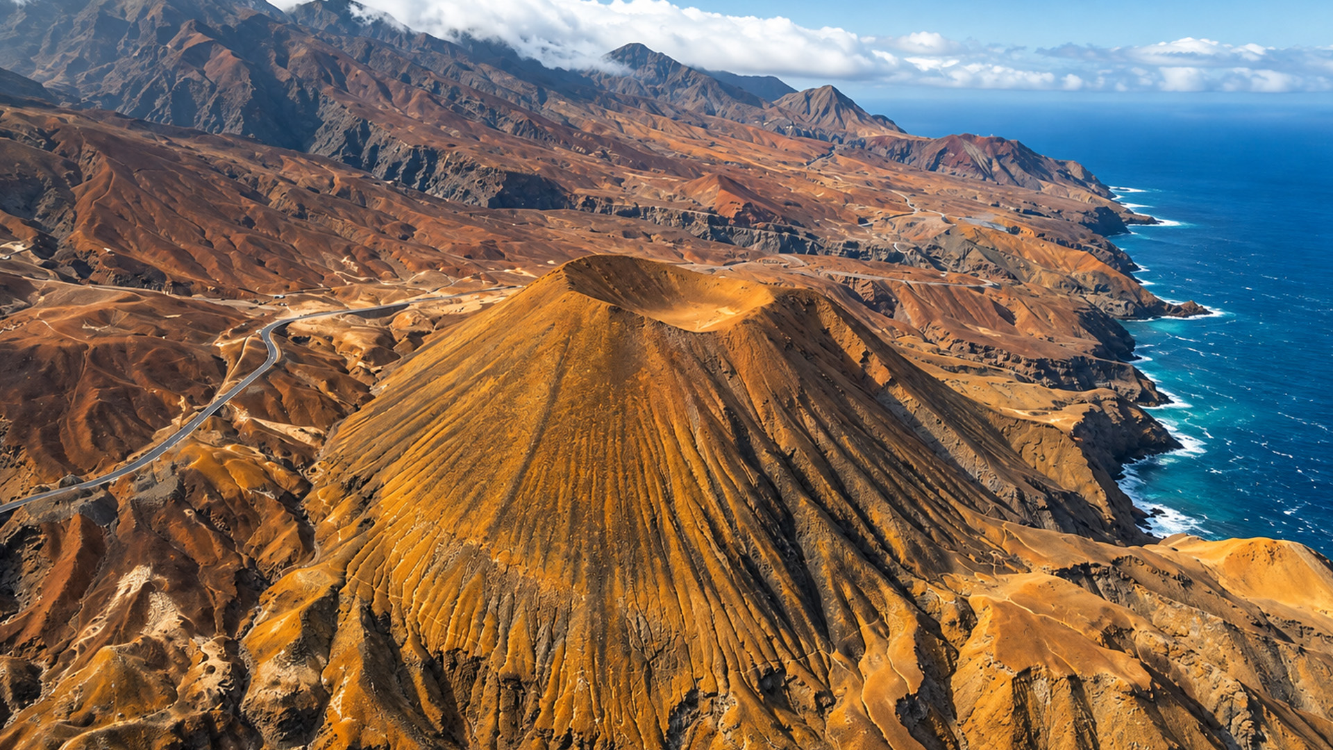 An isolated volcanic cone along a rugged coastline