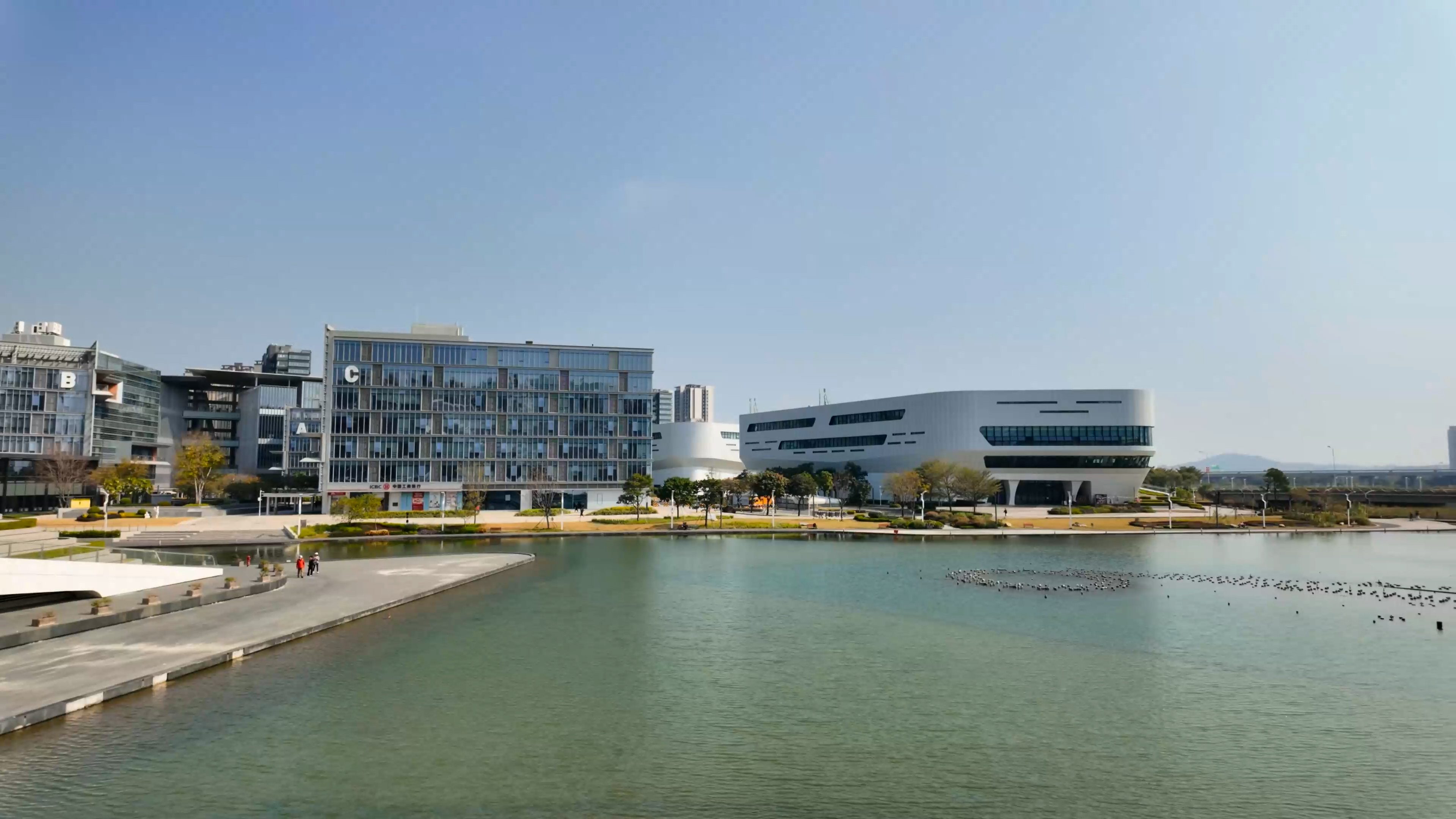 A strange white building overlooks this peaceful lake in China