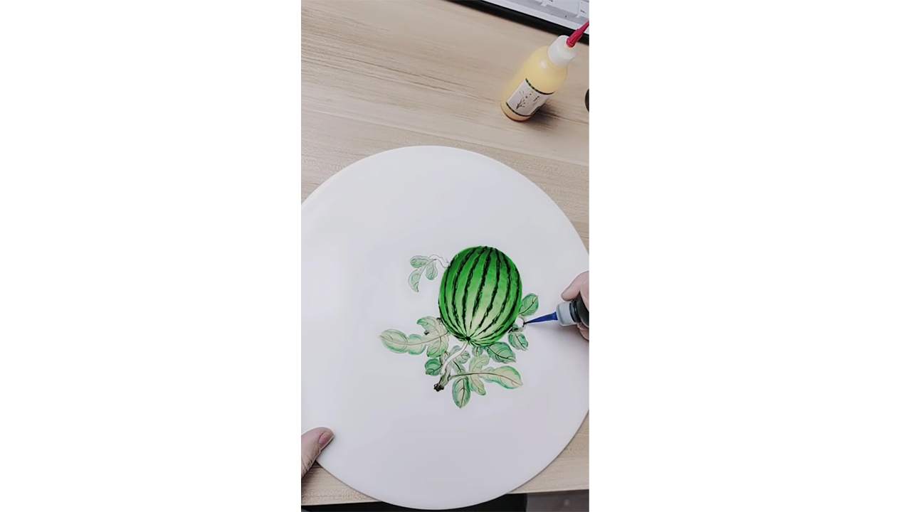 Painting realistic green watermelon with colored ink creating fresh ...