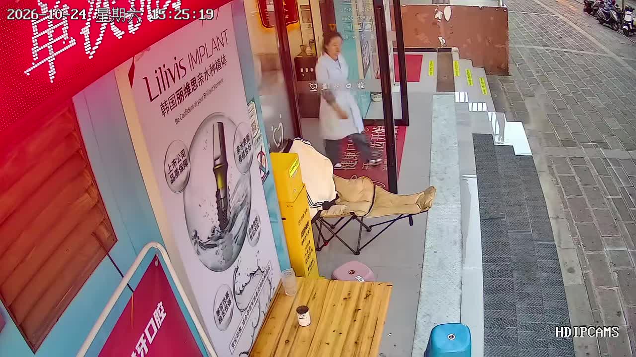 Folding chair collapses beneath woman outside a dental clinic in ...