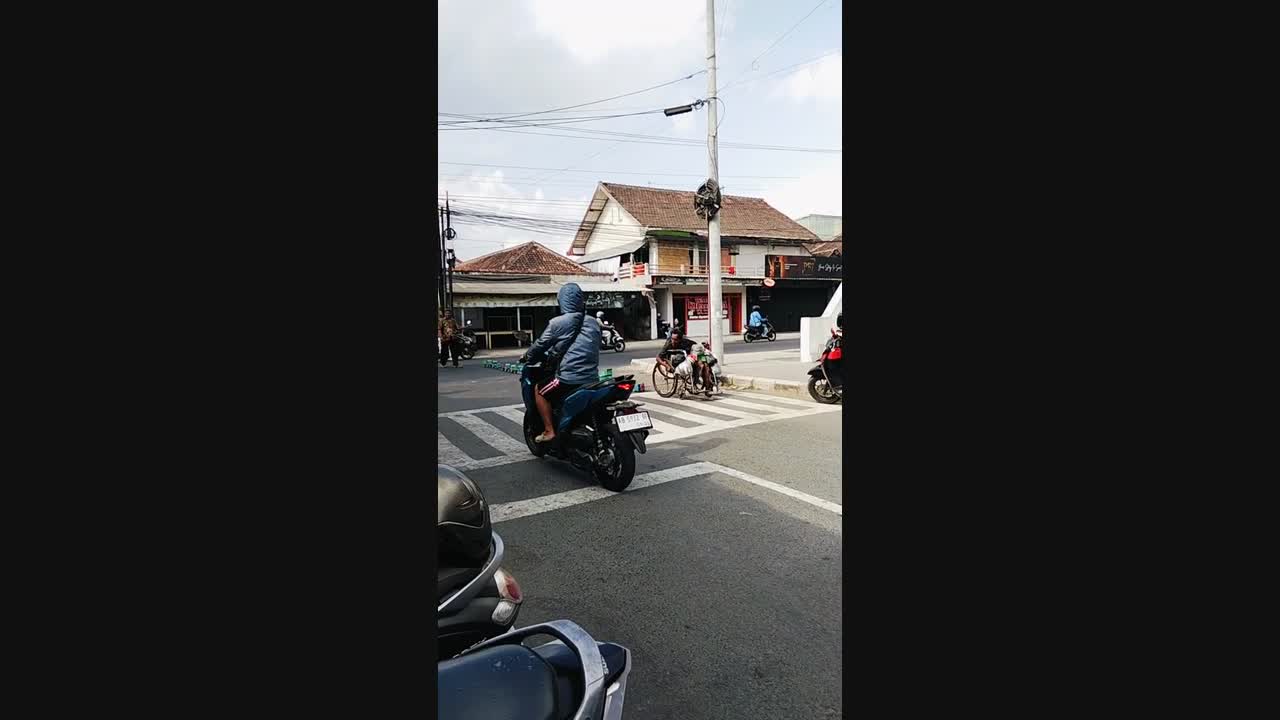 Wheelchair user pulls a long line of toy trucks behind his chair