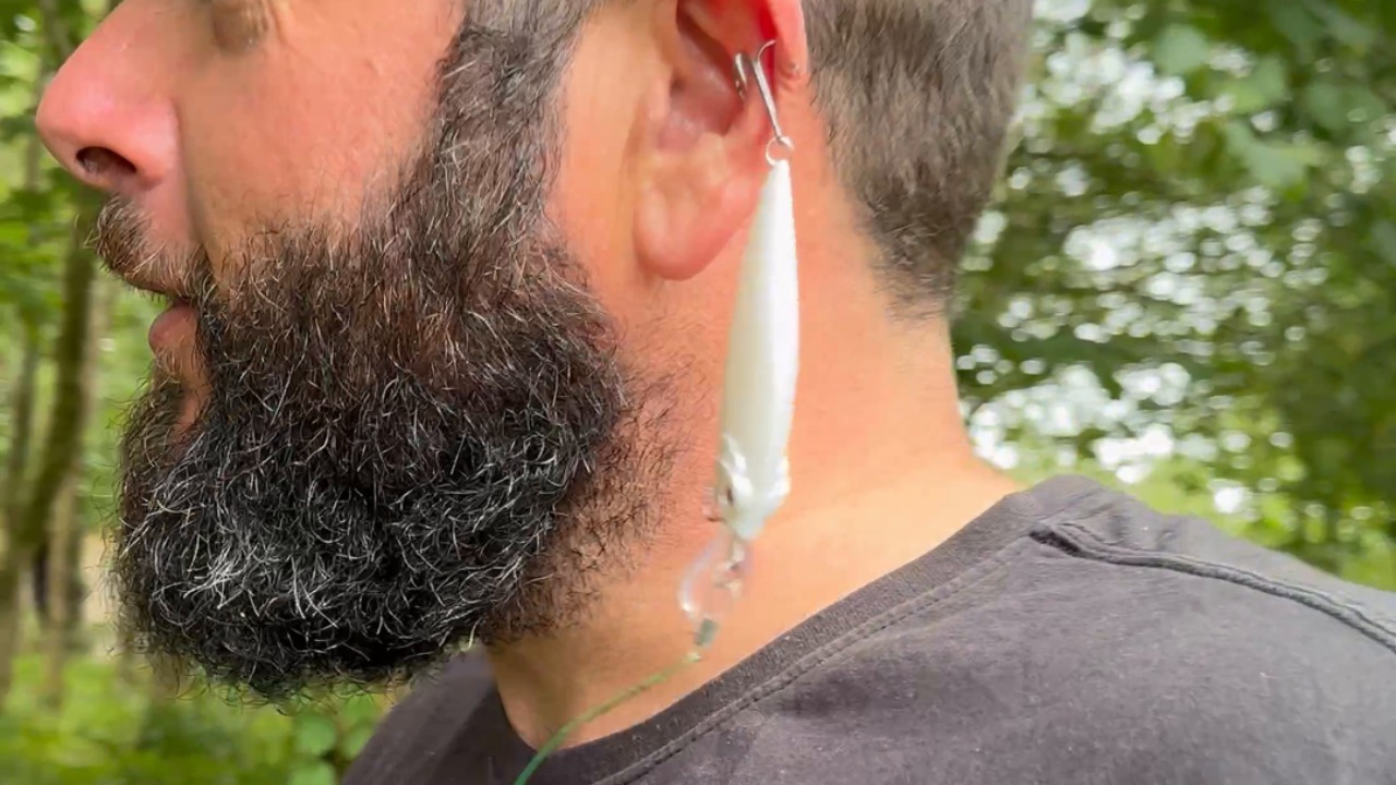 Hilarious fishing fail: Pike hooks lure right into dad's ear!