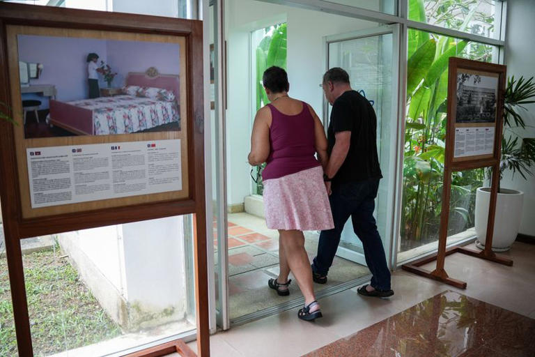 American couple Paul Montaya, 68, and Lynn Montaya, 64, from Colorado, U.S., who hoped to travel the world together while living aboard the Villa Vie Odyssey cruise ship, walk out the hotel during an interview with Reuters after being forced to disembark in Cambodia, as the operator said rising fuel prices linked to conflict involving Iran had made operations prohibitively expensive, in Preah Sihanouk province, Cambodia, October 29, 2026. REUTERS/Soveit Yarn