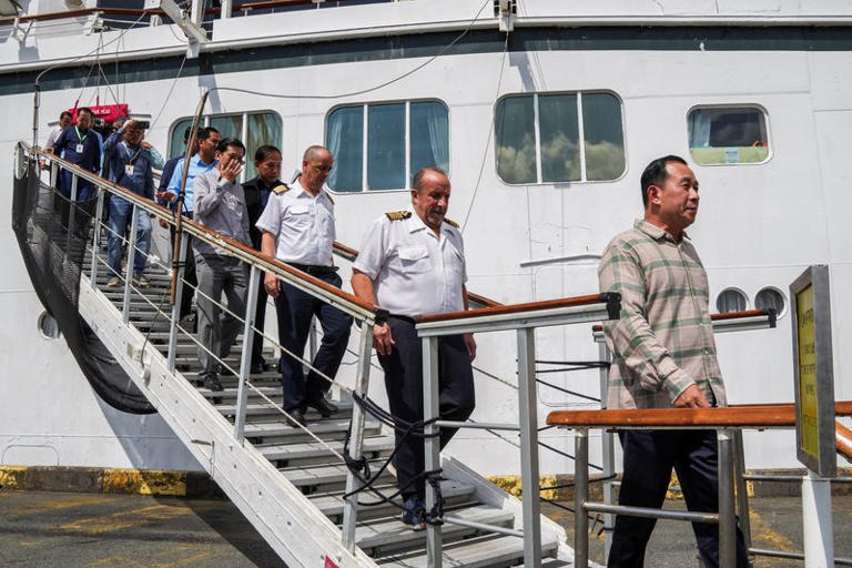 Captain Emanuele Giudice of the Villa Vie Odyssey cruise ship and Cambodia's Minister of Tourism Huot Hak disembark the vessel, which is docked at Sihanoukville Autonomous Port after permanent residents living aboard the vessel were forced to disembark in Cambodia, as the operator said rising fuel prices linked to the war in Iran had made operations prohibitively expensive, in Preah Sihanouk province, Cambodia, October 29, 2026. REUTERS/Soveit Yarn