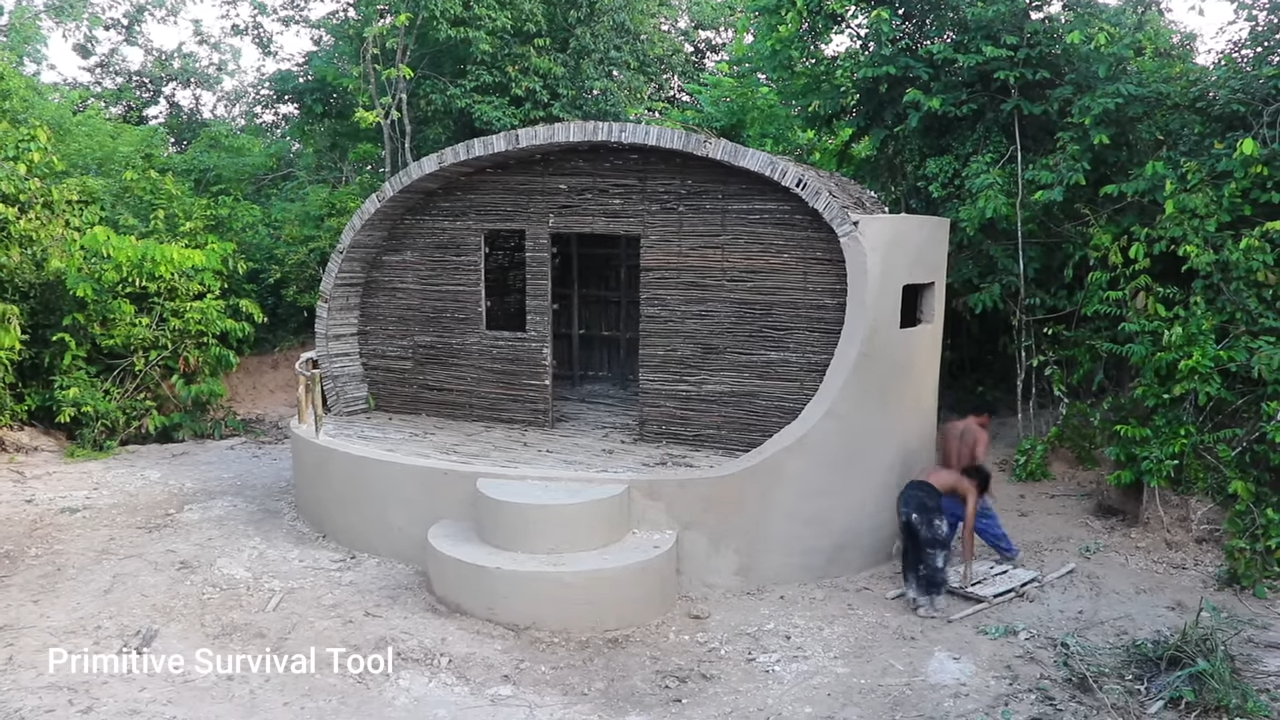 Primitive builders carve an underground house by hand