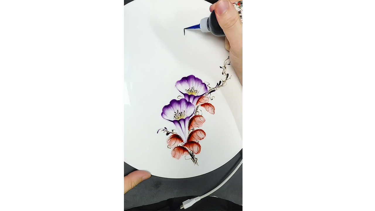 Painting elegant purple morning glory flowers with colored ink creating ...