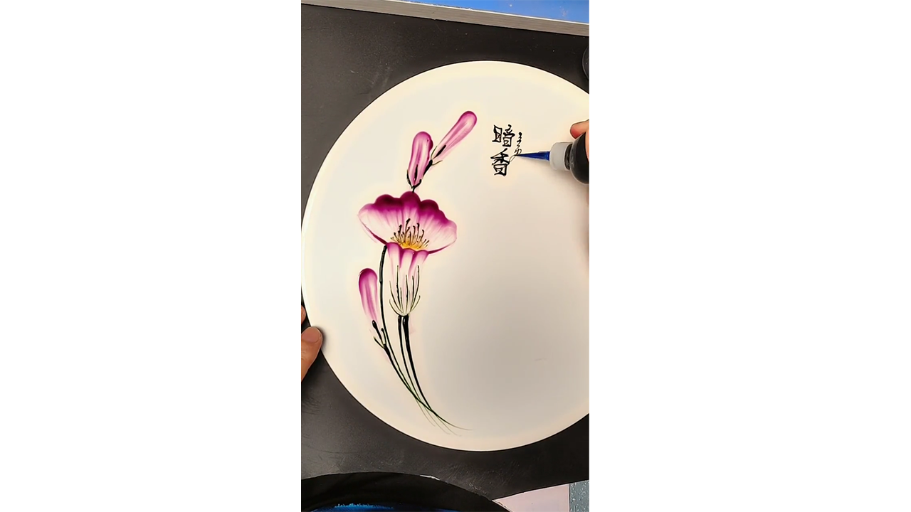 Painting elegant pink flowers with colored ink creating delicate ...