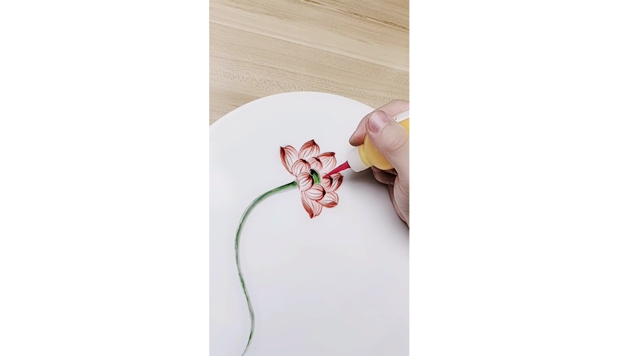 Painting delicate red lotus flower with colored ink creating elegant ...