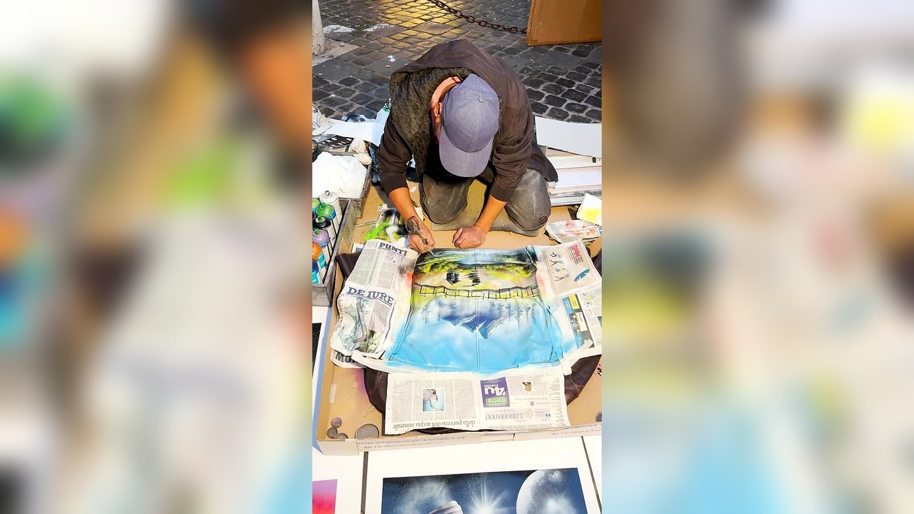 A woman finds a street artist spray painting in Rome