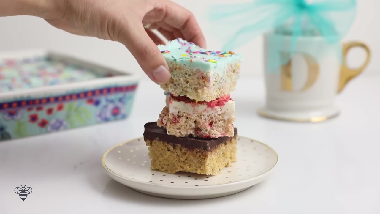 Three homemade Rice Krispies treats with chocolate layers that go ...