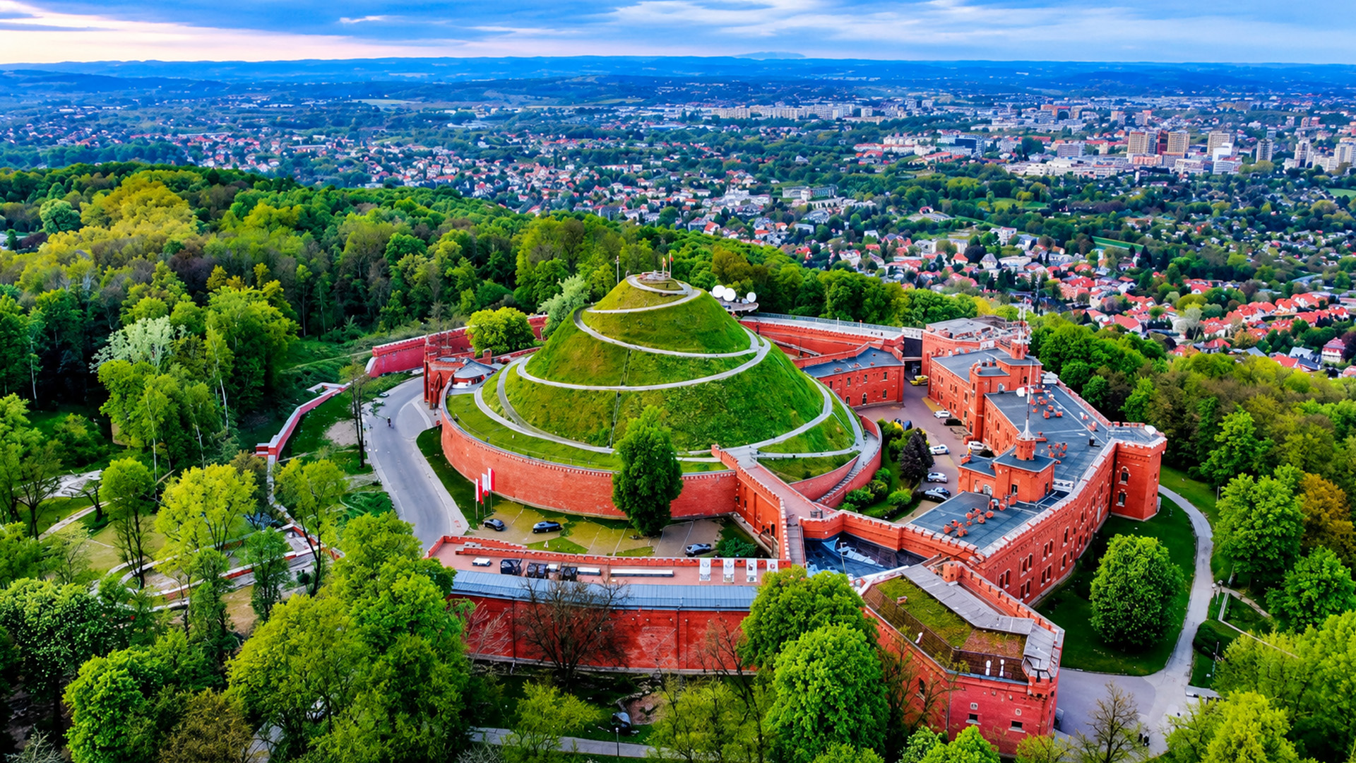 Poland's city skyline unfolds beneath a historic monument