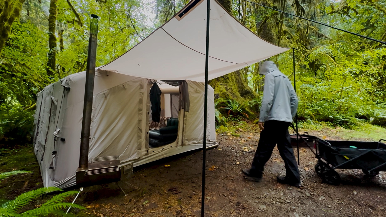 Luxury tent camping in a rainforest during heavy rain