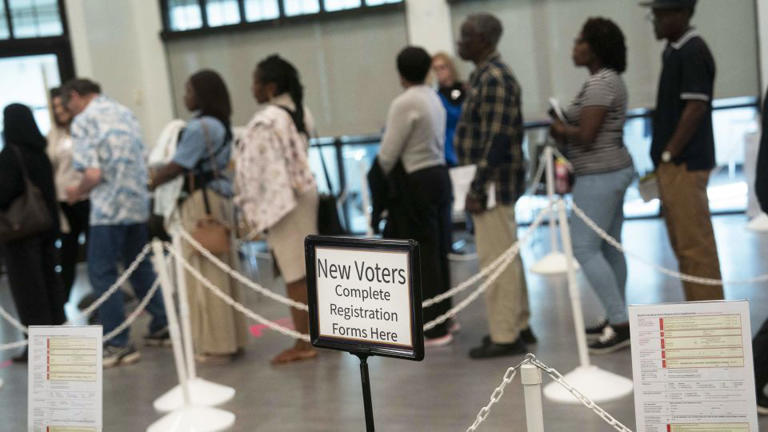 People wait to vote in early voting for the midterm elections on October 25 in Cary, North Carolina. - Allison Joyce/AFP/Getty Images