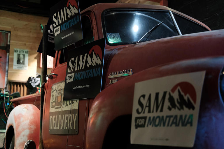 Forstag campaign signs adorn a decorative car in a Montana bar.